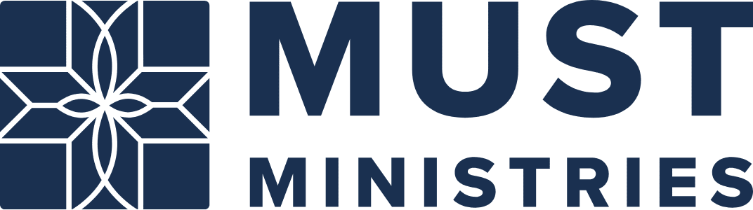 Dark blue logo with a geometric star or cross design on the left, followed by the words “MUST MINISTRIES” in bold, uppercase letters on the right.